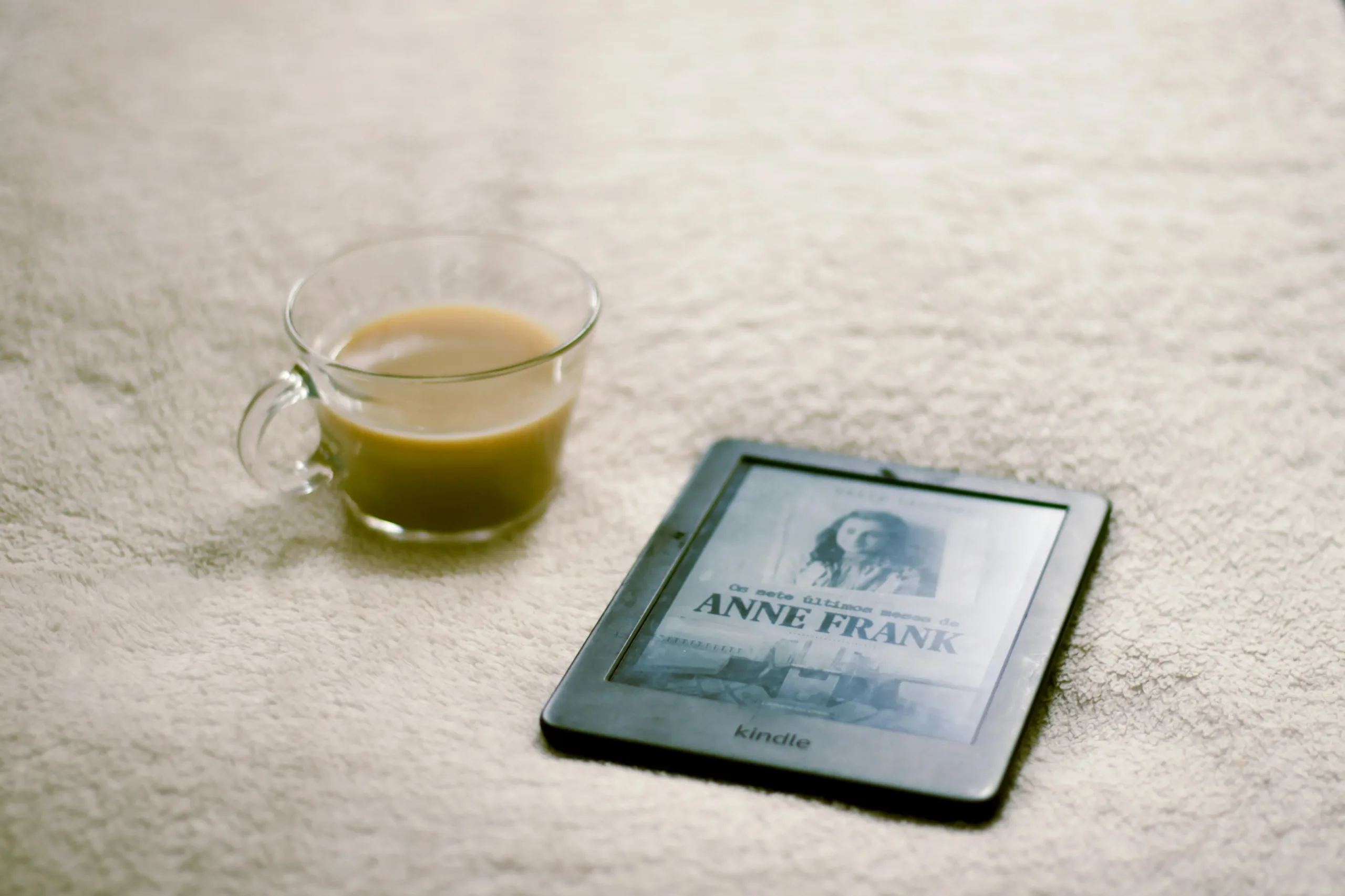 a cup of tea and kindle paperwhite