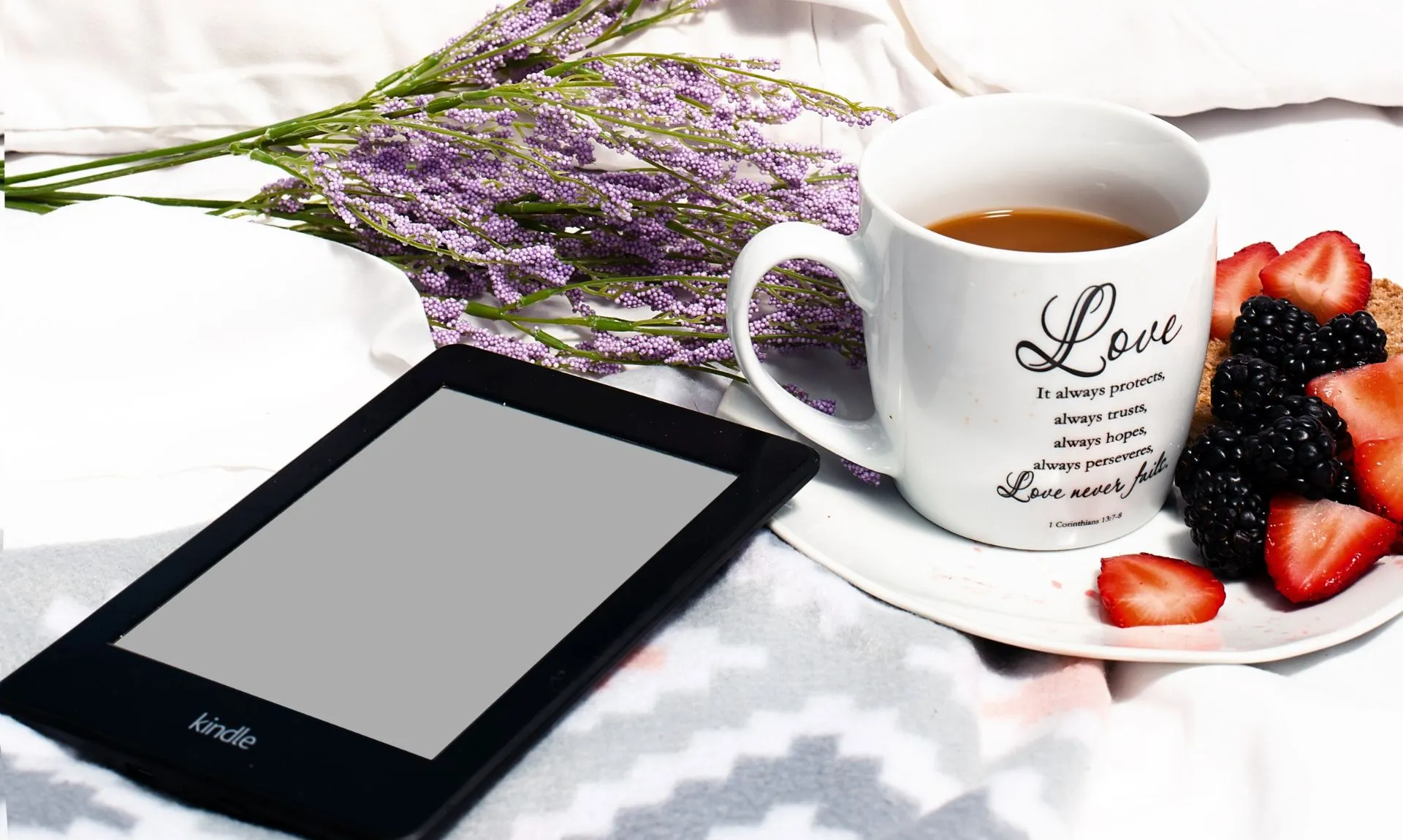 a cup of tea next to amazon kindle paperwhite