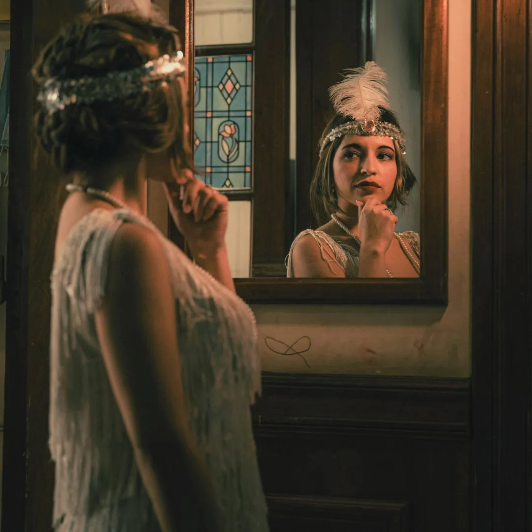 Daisy looking at a mirror in The Great Gatsby