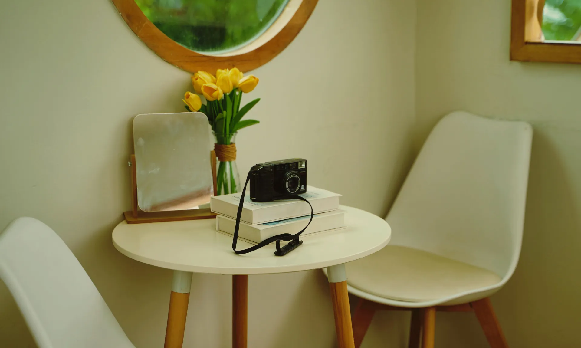 a black camera on top of the books