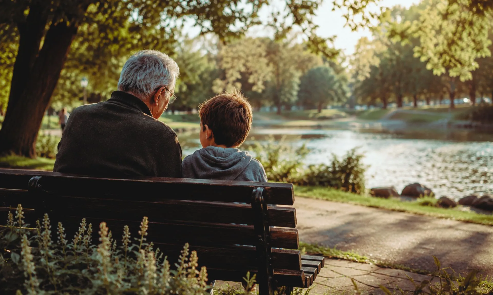 grandfather nd grandson sitting in a park
